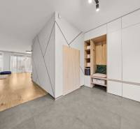 Interior of a 4-room apartment with wood-patterned flooring and built-in cabinets.
