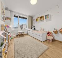Children's room in a 4-room apartment with toys, a bookshelf, and a floor with a wooden decor.