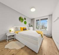 Bedroom with a bed and wall decorations, floor with wood decor.