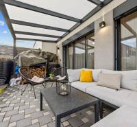 Outdoor seating with a sofa and chairs at a 4-room apartment on Topoľová Street in Rovinka.