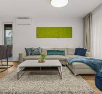 Living room with a gray sofa, green painting, and wooden decor flooring in a 4-room apartment.