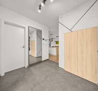 Interior of a 4-room apartment with tiled flooring and wood-patterned flooring.