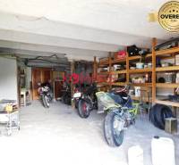 Garage in commercial premises with storage shelves and parked motorcycles.