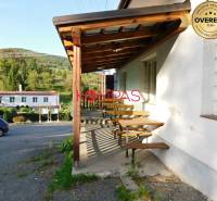 Wooden terrace of commercial premises in Vígľašská Huta-Kalinka, parking lot, surrounding nature.