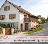 A stone family house with wooden shutters in commercial premises in Vígľašská Huta-Kalinka.