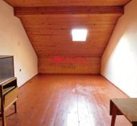 Attic space with a sloped ceiling and wooden floor, suitable for commercial premises.