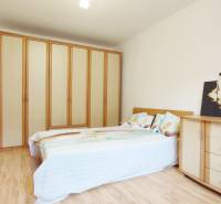 A bedroom with a bunk bed, wardrobe, dresser, and floor with a wooden decor in a two-room apartment.