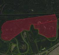 Aerial view of agricultural and forest lands around the town of Boľ.