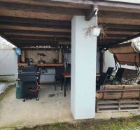 A family house in Tornyosnémeti with a covered terrace, grill, swing bench, and dining area.