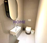 Bathroom in a 3-room apartment with a mirror, sink, and wall-mounted toilet.