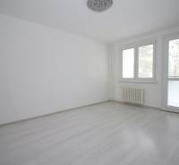 A room in a 3-room apartment with a wood-decor floor and large windows.