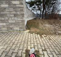 A brick fence and concrete paving on residential plots in Veľká Bytča.