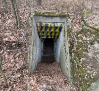 Entrance to the underground bunker among the trees on the property - housing near Veľká Bytča.