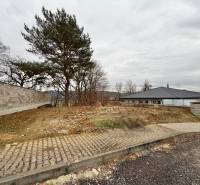 A residential plot in Veľká Bytča in the town of Bytča with a walkway and trees.