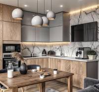 A kitchen in a 3-room apartment with a wooden decor floor and marble walls.