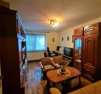 Living room in a family house with furniture and flooring featuring a wood design.