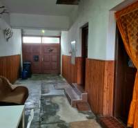 Interior of a family house with entrance doors, a chair, and wall decorations.
