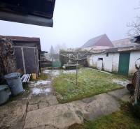 Family house in Chtelnica on Námestie 1. mája with a garden, shed, and waste containers.