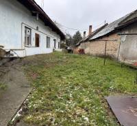 A family house with a garden on Komenského Street in Šurany, next to original buildings.