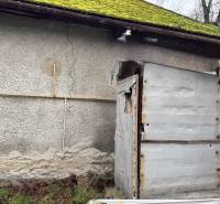 A family house on Komenského Street in Šurany with an older facade and moss on the roof.