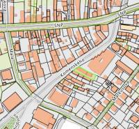 The map shows Komenského Street in Šurany, surrounded by family houses.