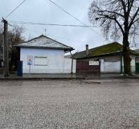 A family house on Komenského Street in Šurany, with a white facade and a tiled roof.