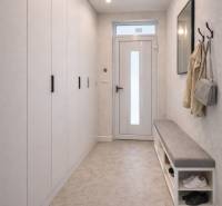 A hallway in a family house with a coat rack, a bench, and a built-in wardrobe.