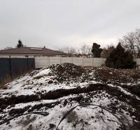 Construction site of a family house in Senec during the winter period with a fence and snow.