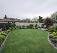 Well-maintained garden with a terrace of a family house in Veľký Grob, rich in greenery and planting.