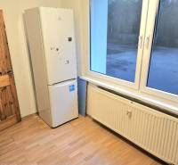 A kitchen corner in a 3-room apartment with an appliance and a wooden decor floor.