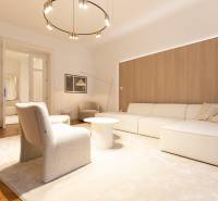 Living room in a 3-room apartment with a sofa, armchair, carpet, and wooden decor flooring.