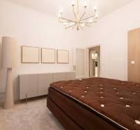 A bedroom with a brown bed, white furniture, and a light fixture in a 3-room apartment.