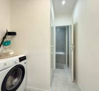 Washing machine in the hallway of a 2-room apartment with access to the bathroom.