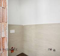 Interior of a family house with an exposed brick wall and tiling in the bathroom.