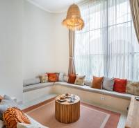 Comfortable seating with cushions and a wooden table in a cozy corner of the villa.