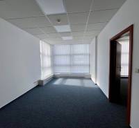 Offices with carpeted floors, white walls, and blinds on the windows.
