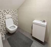 A bathroom in a 3-room apartment with a toilet and a sink, tiles with a geometric pattern.