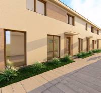 The flat facade of the building with tall windows and a sidewalk on Litoměřická Street in Topoľčianky.