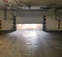 A half-open garage door leads outside, the surroundings are illuminated by indirect light.