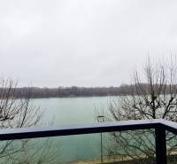 View of the river from the balcony, bare trees, gloomy weather, Dvořákovo nábrežie in Bratislava.