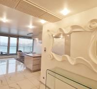 Luxury interior of a 3-room apartment with large windows and a stylish mirror.