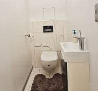 Bathroom in a 3-room apartment with a built-in toilet and sink, floor with marble decor.