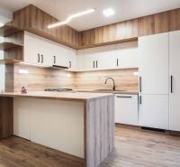 A kitchen unit with a wooden decor floor in a family house.