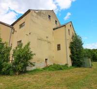 A building in Veľké Uherce surrounded by greenery and a grassy plot.