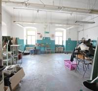 An abandoned room in a building with white walls and blue details.