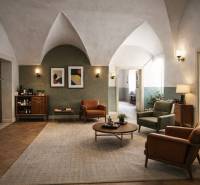 The interior of a building with wood-patterned flooring, comfortable furniture, and decorative elements.