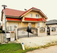 A family house in Ratkovce with a red roof and a landscaped exterior.