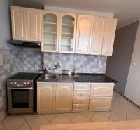 A kitchen unit in a 2-room apartment with tiles and a gas stove.