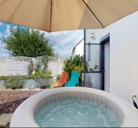 In a family house in Stupava, there is a hot tub with a terrace under a sun umbrella.