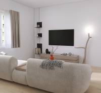 Living room in a three-room apartment with a comfortable sofa and a TV on the wall.